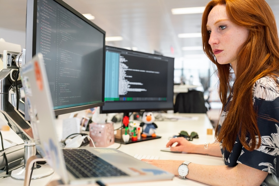 A woman in an office researching intelligent search on her computer