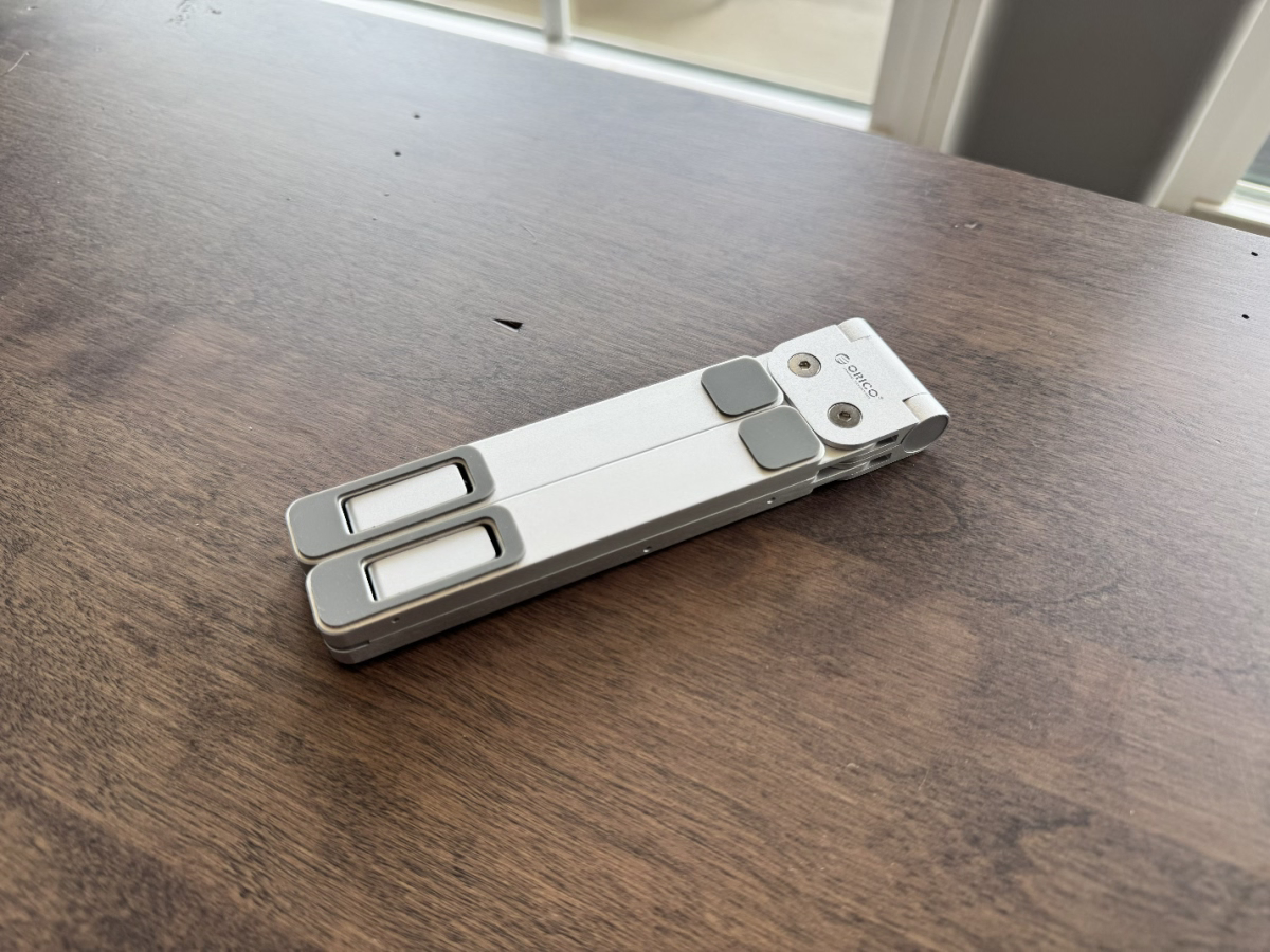 ORICO PN-1 laptop stand fully folded on a wooden table
