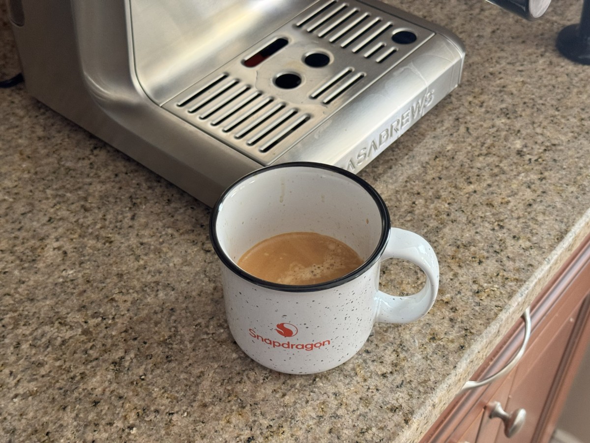 Freshly brewed espresso in a ceramic mug next to the Casabrews Ultra Freshly brewed espresso in a ceramic mug next to the Casabrews Ultra