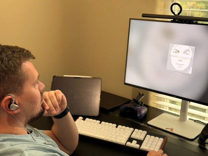 User listening to music with ATK Horizon earphones at a desktop setup. User listening to music with ATK Horizon earphones at a desktop setup.