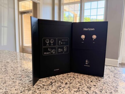 ATK Horizon gaming earbuds packaging opened to reveal the earphones and accessory compartment.