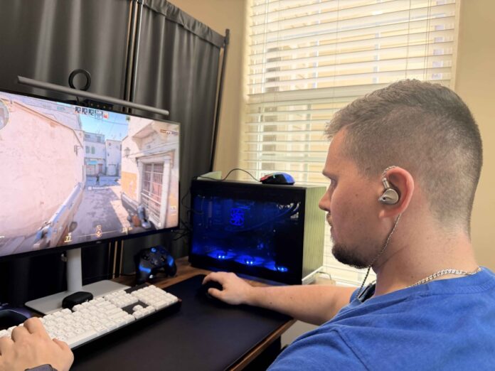 Gamer wearing ATK Horizon earbuds while playing Counter-Strike 2 on a desktop PC Gamer wearing ATK Horizon earbuds while playing Counter-Strike 2 on a desktop PC