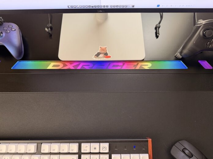 Rainbow RGB lighting mode illuminating the DXRacer logo and accent panels DXRacer Tidal XL Gaming Desk