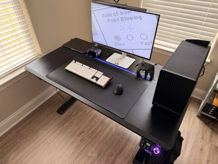 DXRacer Tidal XL gaming desk with RGB lighting, desktop PC, and monitor setup. DXRacer Tidal XL Gaming Desk