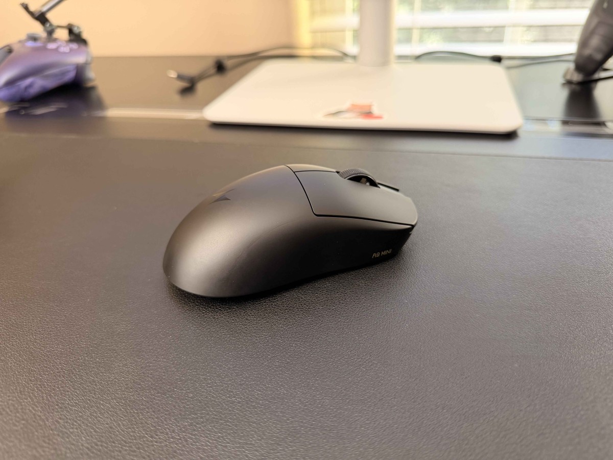ATK A9 Mini+ wireless gaming mouse shown from the side on a desk