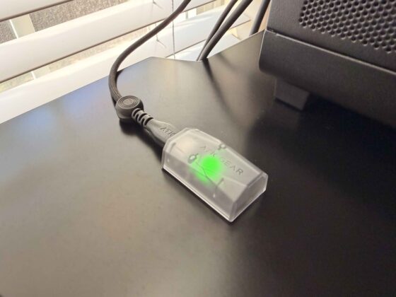 ATK Gear 8K wireless receiver connected to a USB cable with its green status light illuminated.