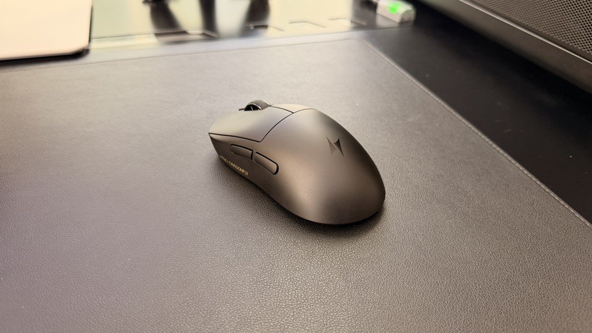 ATK Dragonfly A9 Mini+ black wireless gaming mouse on a black desk mat.