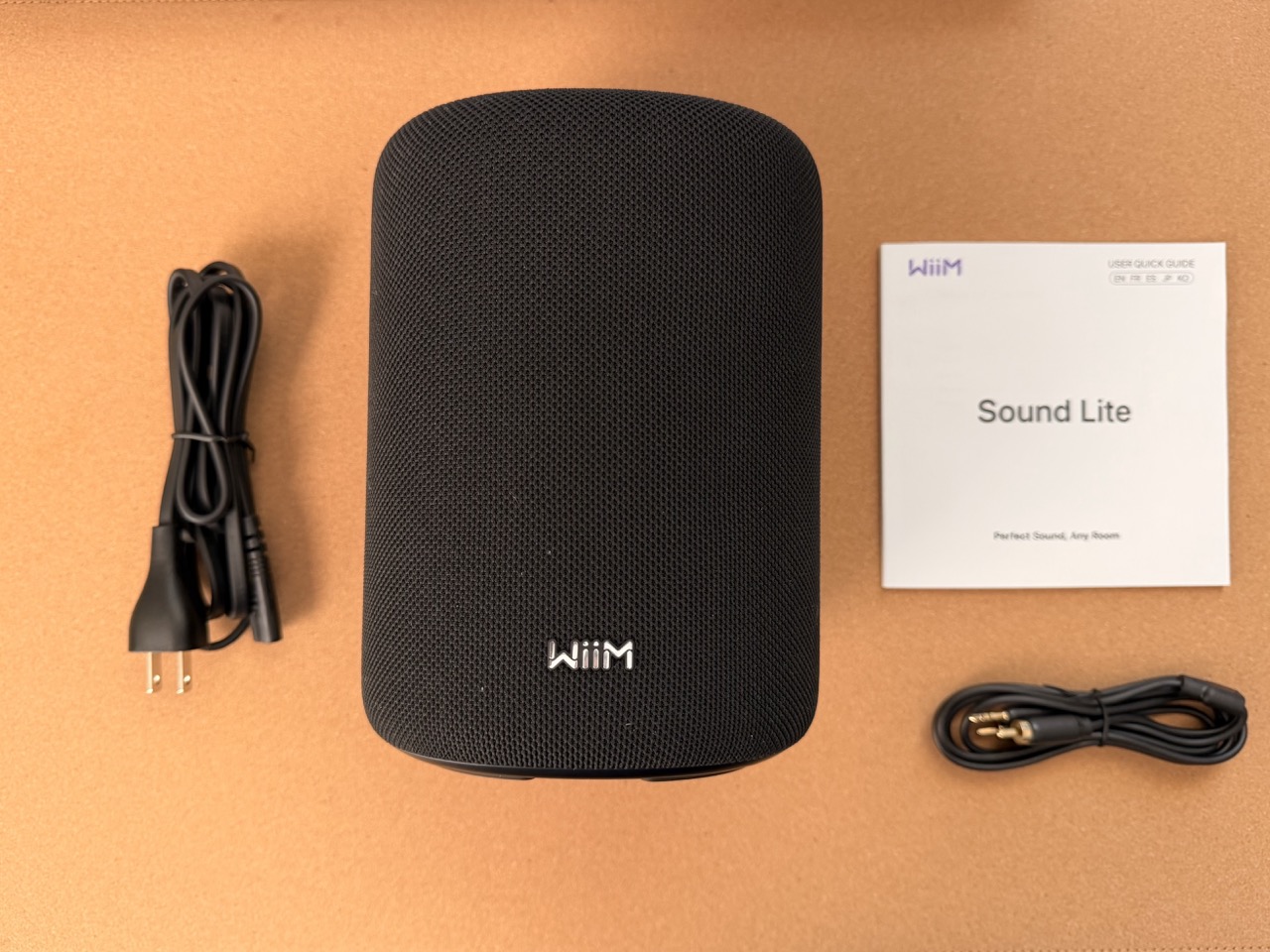 WiiM Sound Lite speaker with included power cable, 3.5 mm audio cable, and quick start guide WiiM Sound Lite speaker with included power cable, 3.5 mm audio cable, and quick start guide