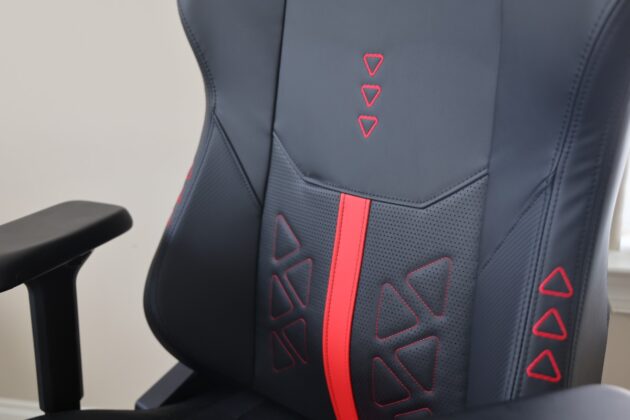 Close-up of the DXRacer Martian Pro XL seat showing perforated upholstery, red stitching, and contrasting center stripe