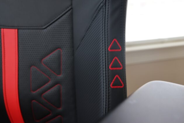 Close-up of the DXRacer Martian Pro XL backrest showing red triangle embroidery, stitching, and textured upholstery